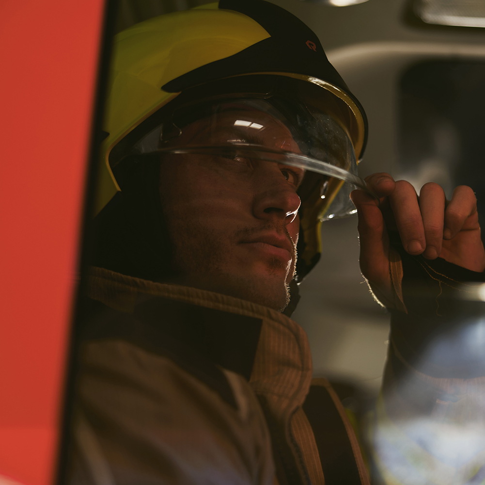 A flamePro Firefighter wearing a rosenbauer helmet - Image